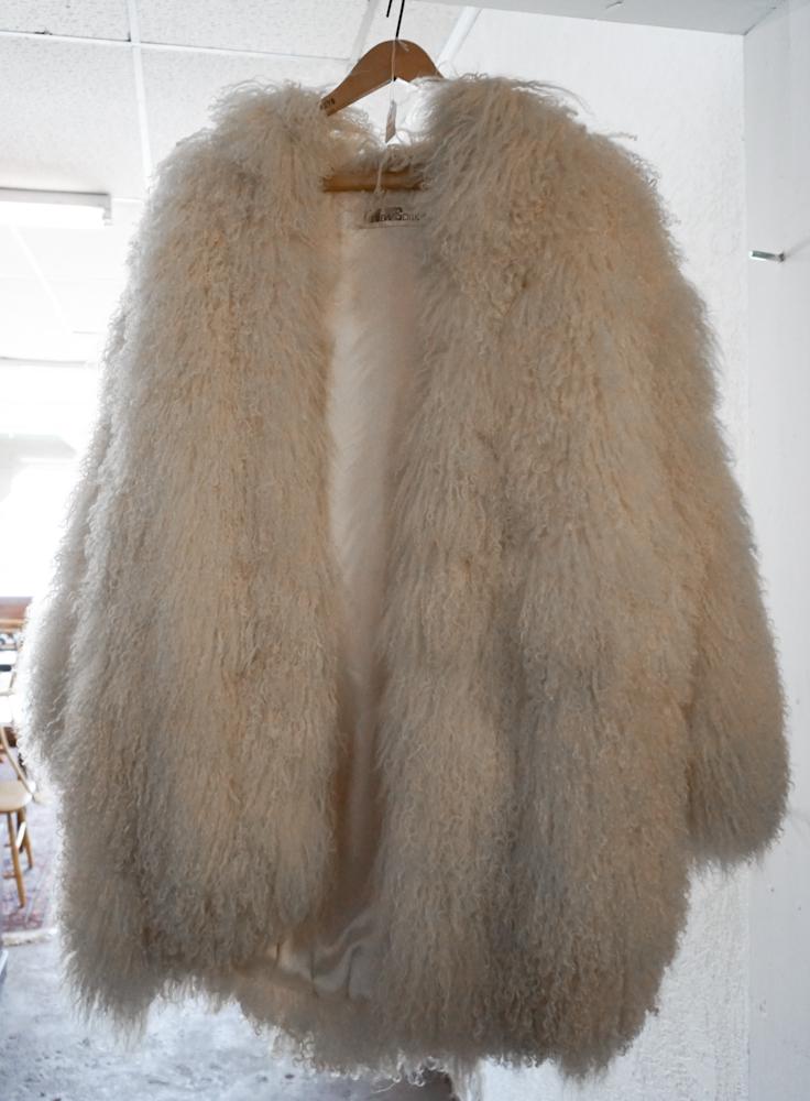 Deco Mid Century Polyester Tibetan Lamb Fur Coat: Mid 20th century, likely 1970. The vintage coat having label at interior of New Edition. Very nice and well kept condition. Sold from the collection of Betty and Ralph Jennings of Gaffney, South Carol