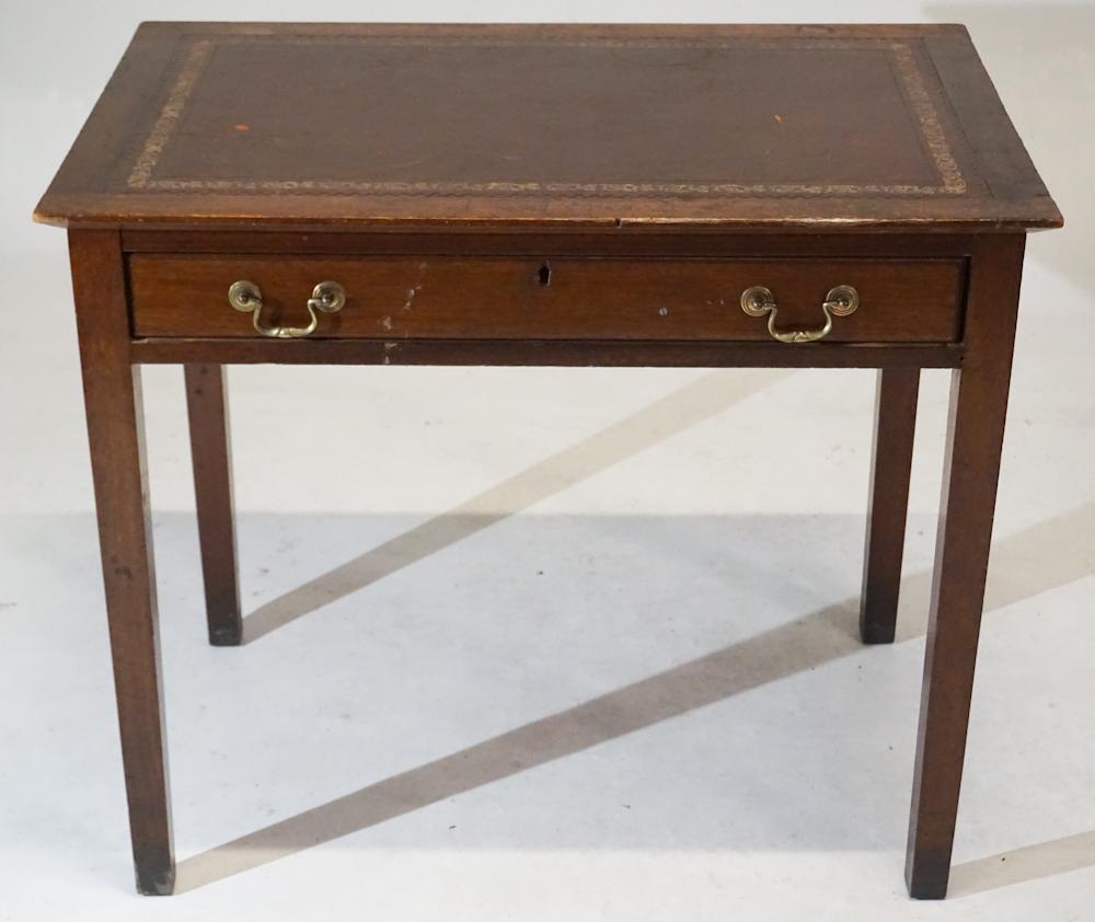 English George III Mahogany Leather Top Desk: Circa 1820. Having a rectangular top centered by a very nicely embossed leather top above a single long drawer at lower case with brass bale handles all resting on tapered legs. H30 1/4" W35 3/4" D23 
