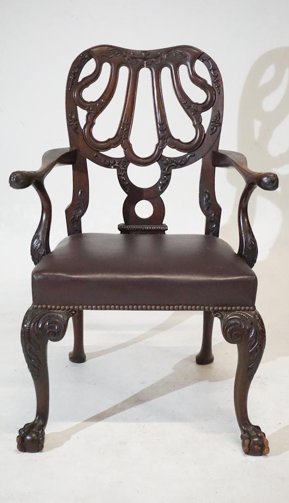 Irish Chippendale Style Carved Mahogany Armchair: Circa 1890. Having a very nicely carved back leading to arms with acanthus tips above leather upholstered seat over acanthus carved knees continuing down to a charming ball and claw foot. H40" W28" D2