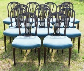 Excellent Set Federal Lyre Back Dining Chairs: Circa 1820. The set of twelve having been brilliantly carved with bell flowers in the lyre back atop an upholstered seat on tapered and reeded legs at the front and tapered slightly arched leg at back