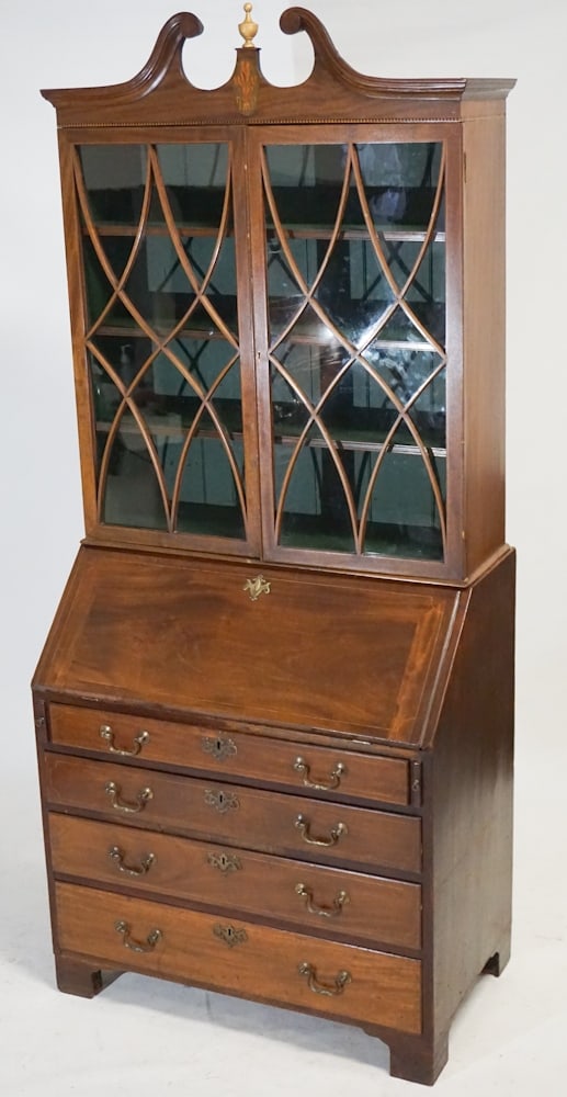 English George III Inlaid Mahogany Secretary Bookcase: Circa 1820. Having a charming crown centered by turned and gilded finial over excellent feather cartouche in satinwood oval over two glazed doors housing three shelves within over the lowercase having
