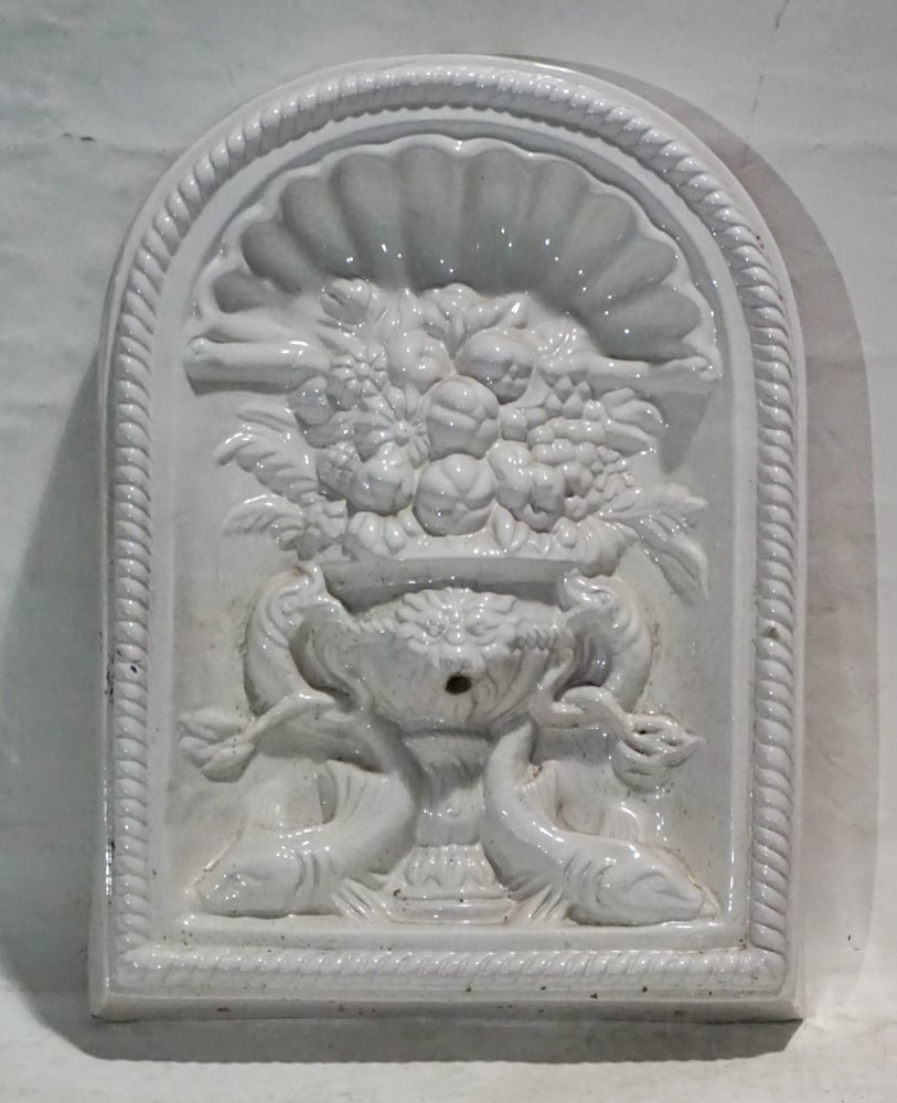 Continental Garden Wall Hanger Fountain: Early 20th century, likely Italian. Nicely sculpted example with white glazed body on terracotta and with classical form. The piece having the fountain spout at lower center and is plumed nicely to wo