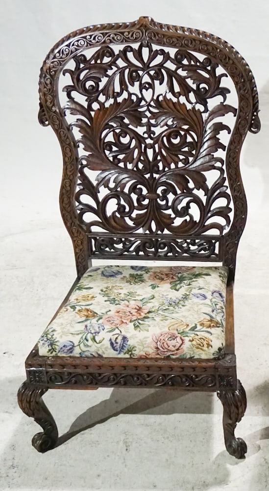 Antique Anglo Indian Carved Rosewood Slipper Chair: Mid to late 19th century. Having excellently carved backrest with flowing frame boasting palm leaves and acanthus above upholstered seat all resting on lower frame with nicely feather carved legs. H35