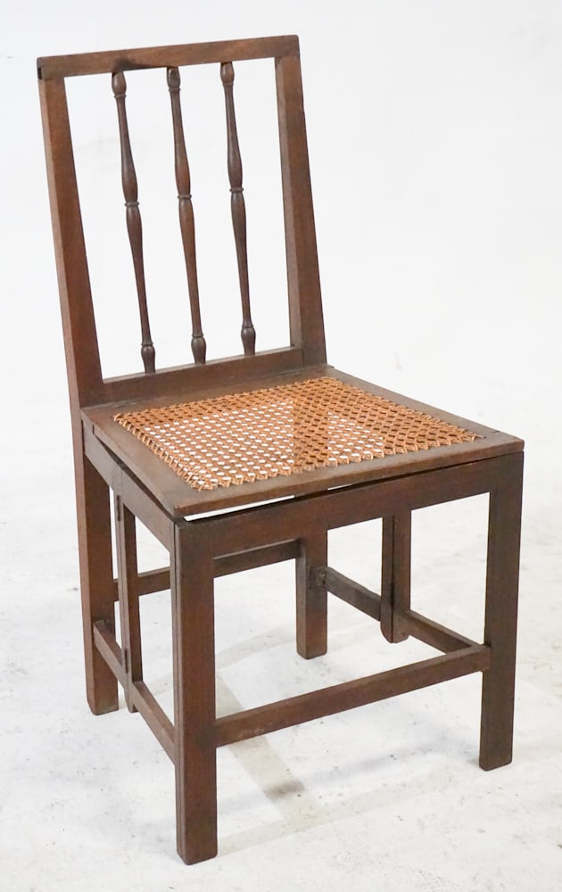 Rare George III Mahogany Campaign Folding Chair: Circa 1810, England. Having a turned wood backrest in square edge frame over the caned seat which is hinged and folds upward over the lower frame having accordion style hinged lower frame to fold and 