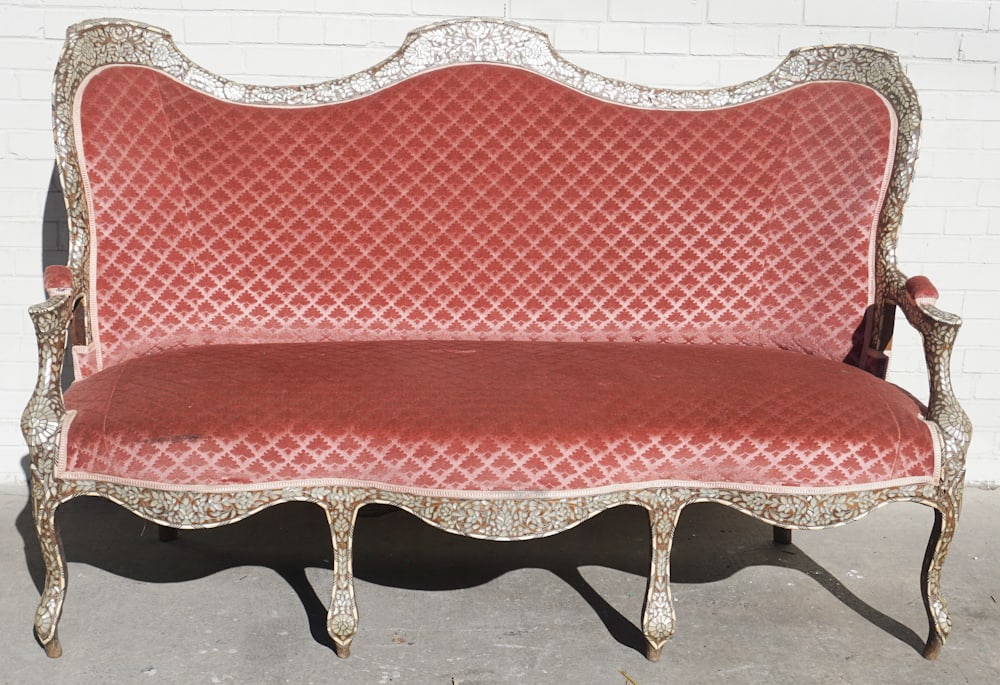 Excellent Antique Persian Inlaid Teakwood Sofa: Circa 1890. Marked at the underside Made In Syria. Brilliantly inlaid with natural camel bone and mother of pearl. The piece has scalloped back leading into carved arms and lower frame all resting on