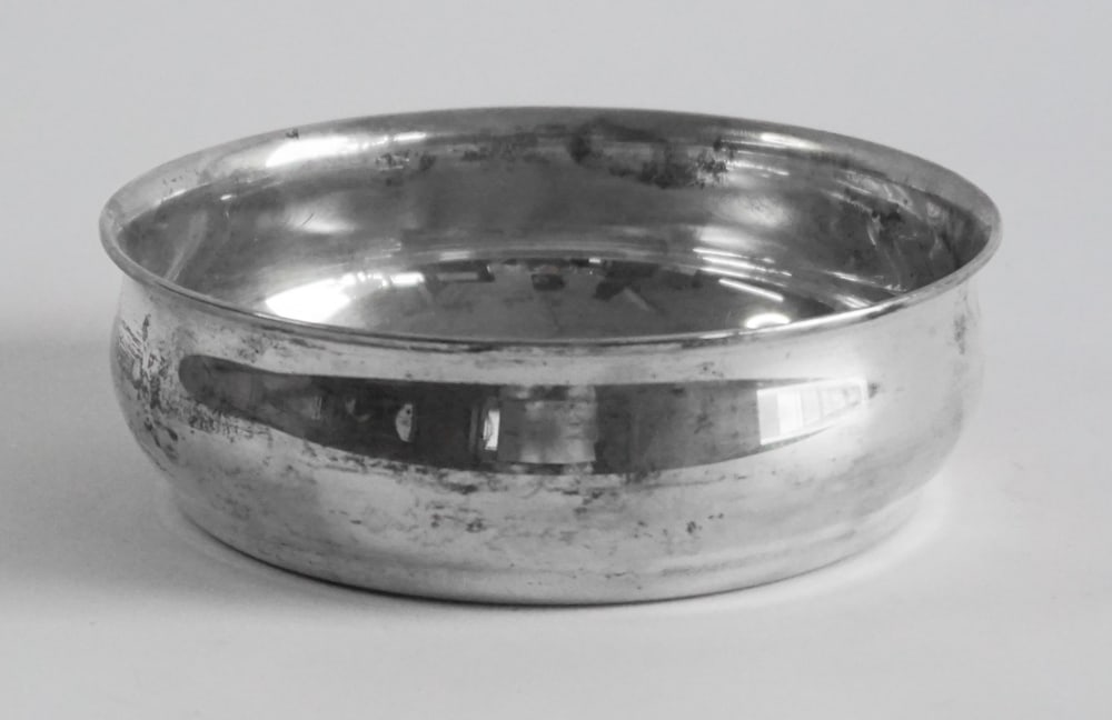 Tiffany & Co Sterling Silver Wine Bottle Coaster: Nicely formed piece with turned wood insert at the center marked at underside with maker's mark. Good condition throughout. W4 3/4" H1 3/4" 141 grams silver only without insert Sold from the collectio