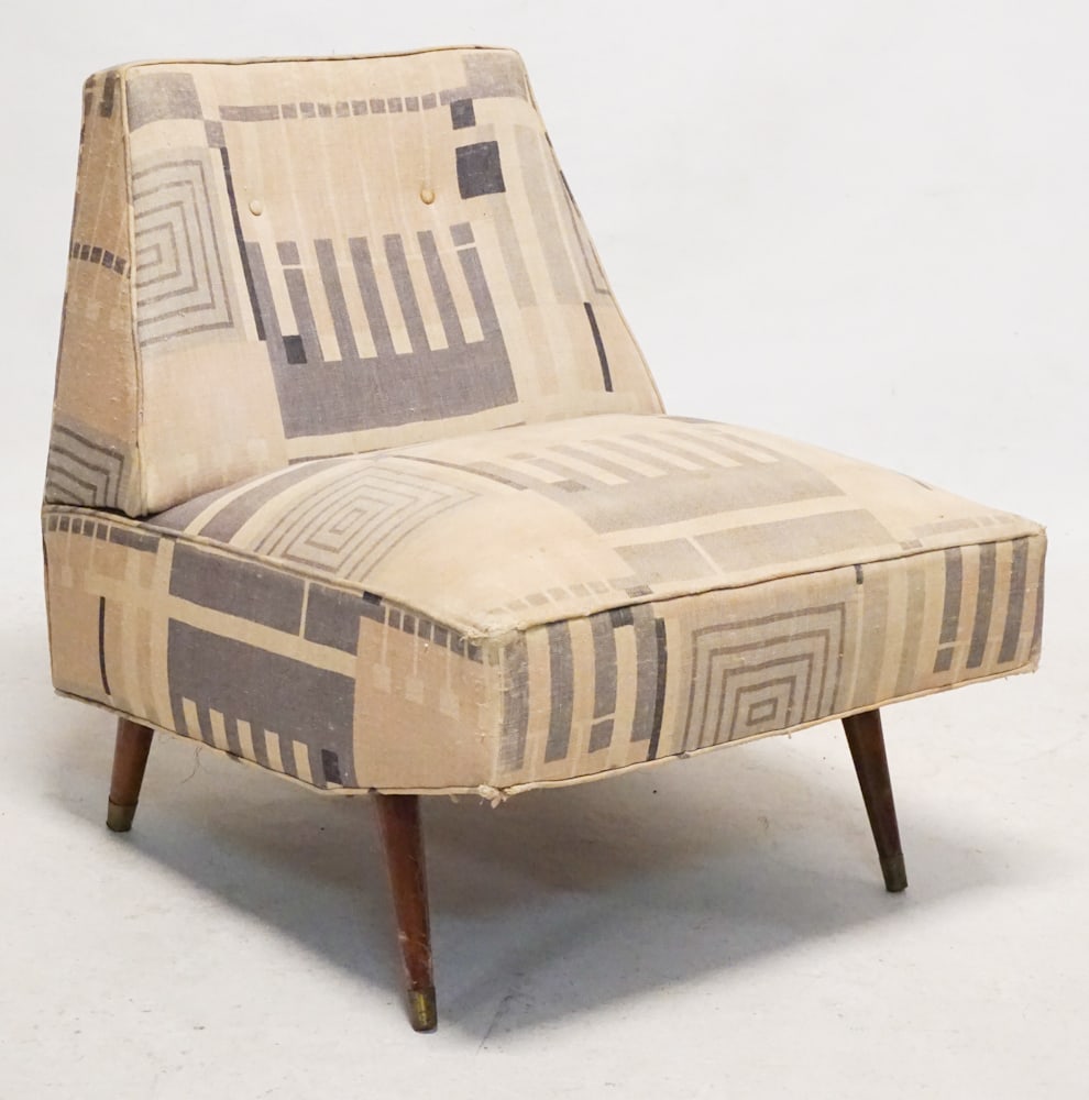 Mid Century Modern Upholstered Easy Chair: Mid 20th century. Having what looks to be its original fabric atop four legs tipped in brass. H29" W24" D27"