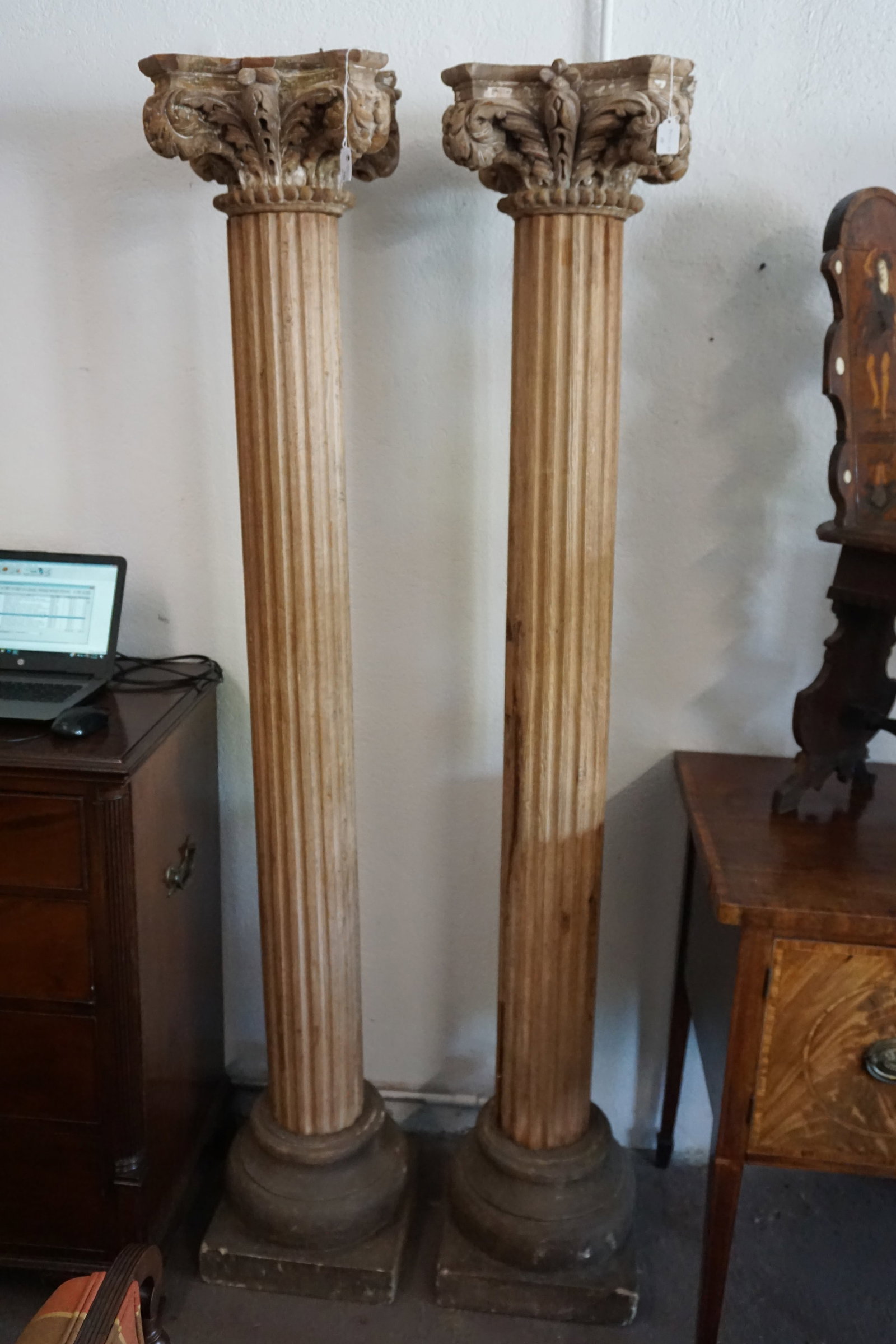 Handsome Pair of Carved Wood and Stone Columns: Europe likely early 20th century. Each carved very nicely with acanthus tops over fluted body on carved stone foot. H 79" W 16"