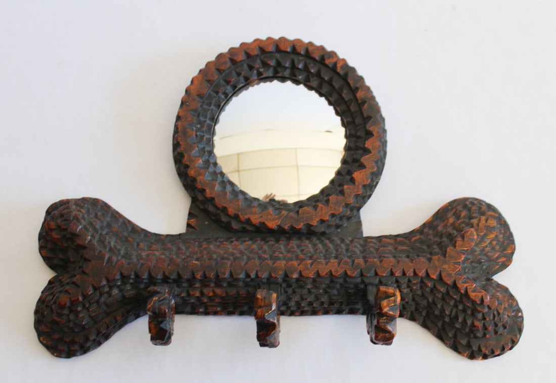 Vintage Tramp Art Mirror Coat or Leash Wall Hanger: Mid 20th century most likely. Very charming carved piece in the form of a dog bone having bullseye mirror at upper center with three hooks to hang from. Good condition throughout. H12" W17" Sold from 