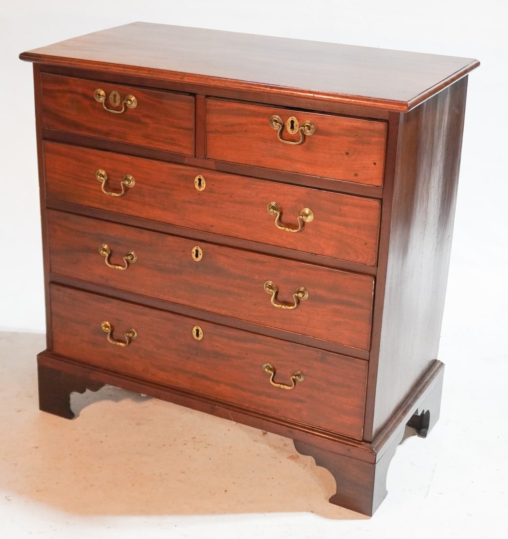 Handsome English George III Mahogany Chest: Circa 1810. Having a rectangular top which is nicely grained over the case housing four slightly graduated drawers all resting atop a nice bracket foot. H35" D18" W34 1/2" Sold from the Braford Collec