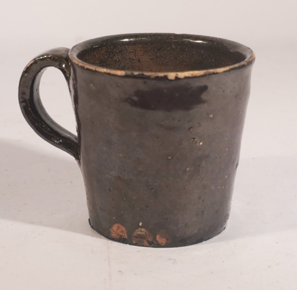Rare Southern Stoneware Edgefield District of South Carolina Cup: Circa 1890 likely Columbia, South Carolina and Edgefield District Baynham or Stork. Handsome cup and a scarce form. No repairs or cracks. H4 1/8" W5 1/2" Sold from the collection of a Lexington gentle