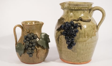 Two Southern Stoneware Decorated Grape Pitchers by Michael Crocker