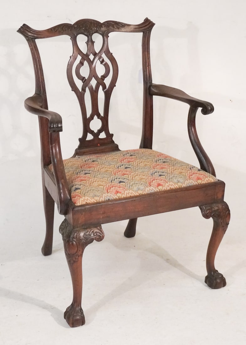 Fine American or English Chippendale Carved Mahogany Armchair: Circa 1770. Having excellently carved and pierced back leading to well carved arms over the seat and frame atop legs having acanthus carved knees leading to an excellently formed ball and claw foot. H