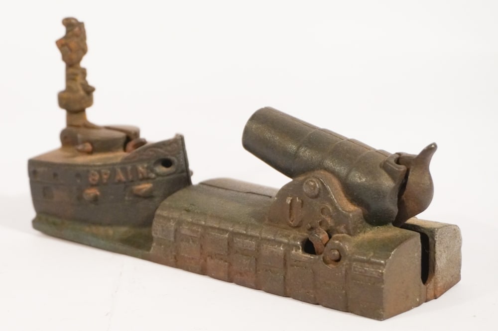 Antique Cast Iron Bank: United States Navy Bank firing on Spanish Ship. Excellent early surface throughout. Well functioning condition as well. Very nice example. H4 1/2" W9" Sold from the collection of a Kinston, NC couple.