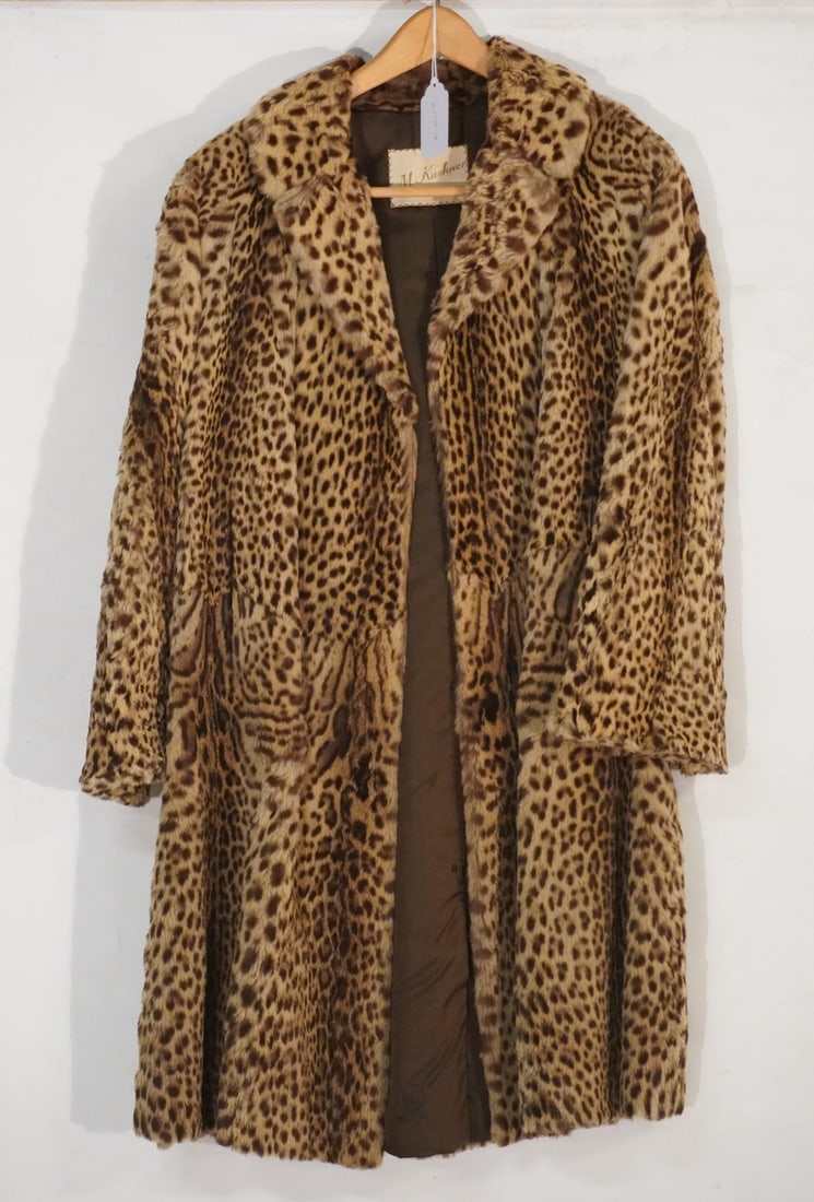Natural Vintage Ocelot Fur Coat: Mid to later 20th century. In excellent well kept condition. Very nice colors throughout. L40" Sold from the collection of a Camden, South Carolina lady.Shoulder to Shoulder 18" Sleeve outside 21" AP