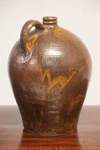 Excellent & Early Southern Stoneware Edgefield District Jug: Circa 1830, Pottersville likely Harry Drake. Excellent form and uncommon darker ashe glaze having excellent runs. The jug having incised knife marks at the upper shoulder. Brilliant example. Small nic