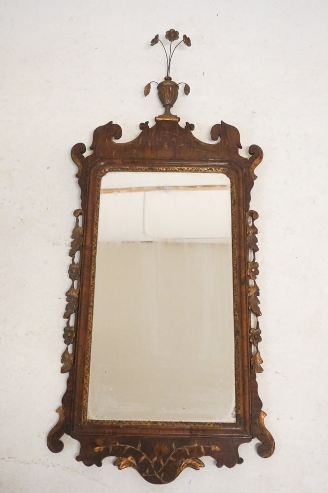 Federal Carved & Gilt Mahogany Looking Glass: Circa 1800. Having a fine wire and urn finial emitting flower stems over the nicely carved frame flanked by gilded floral trim. Nice early surface throughout. H44 1/2" W19" Sold from the collection of