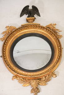 Very Fine NeoClassical Period Carved & Gilt BullsEye Mirror: Circa 1820, American or English. Having excellent form and brilliantly carved eagle over circular frame adorned with carved and gilt acanthus trim centered by the bold and handsome convex mirror at ce
