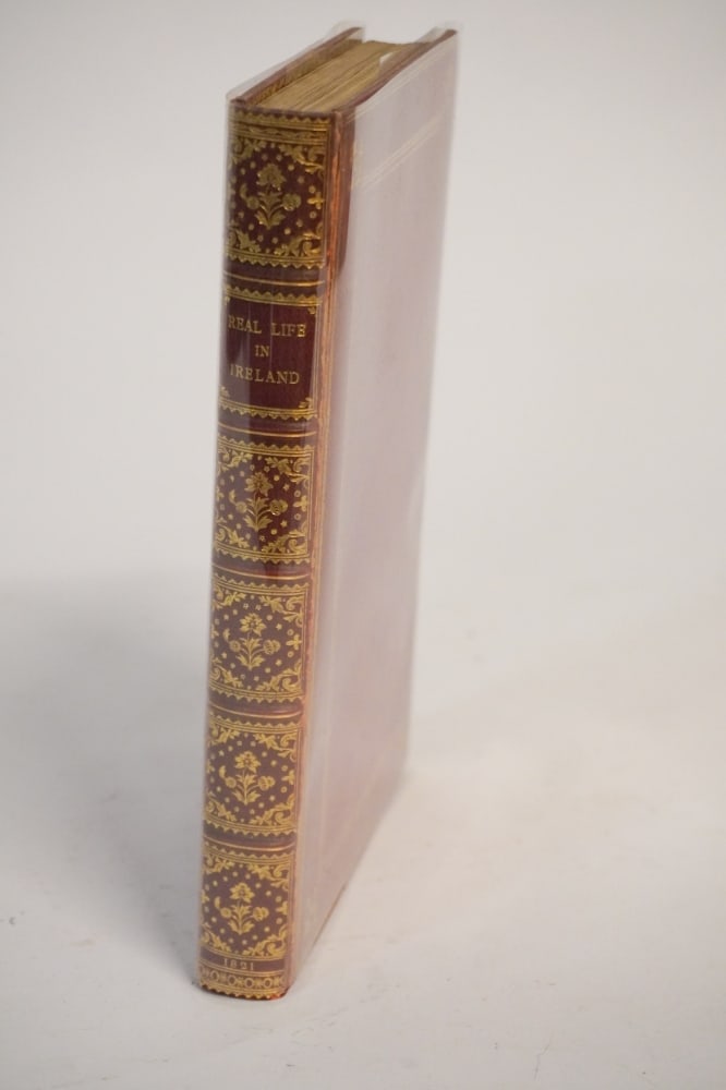 Uncommon First Edition Leather Bound Volume Real Life in Ireland: Published in London 1821. The book has hand colored images and maps within. Very nicely bound and in good overall well kept condition. Sold to benefit the Cat About Town Cat Rescue of Camden, South Ca
