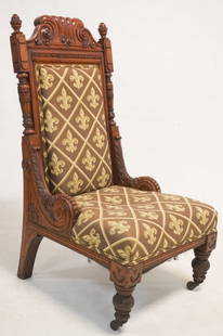 Very Fine American Modern Gothic Aesthetic Movement Carved Oak Slipper Chair: Circa 1870. Having brilliantly carved frame with excellent upholstery atop four handsomely carved legs atop casters. Very nicely kept in good overall condition. H47" W23" D25" Sold from the collection