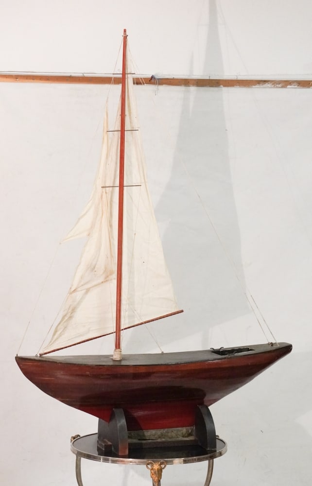 Excellent Antique Wood Hand Crafted Functioning Pond Sailing Yacht: Early 20th century example having brilliant form and style. This is a functioning pod yacht and made to use. The piece stands nicely atop its custom base. L51" H74" (with sail and base) Sold from the 