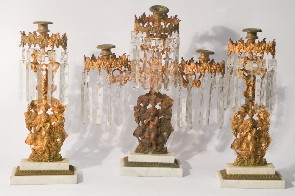 Antique Neoclassical Gilded Crystal Girandoles: Mid 19th century likely Philadelphia by Cornelius and Co. Handsome set hung with prisms and boasting a fine gilt surface. H18 1/2" Sold from the collection of a Charleston gentleman.