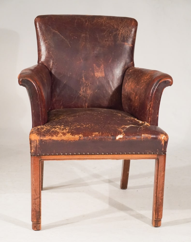 Handsome English George III Leather Armchair: Circa 1800. Having early leather upholstery with some tattering but very charming nonetheless. The piece stands nicely atop four square legs. H38" W27" D24" Sold from the collection of Tonya and Bob A