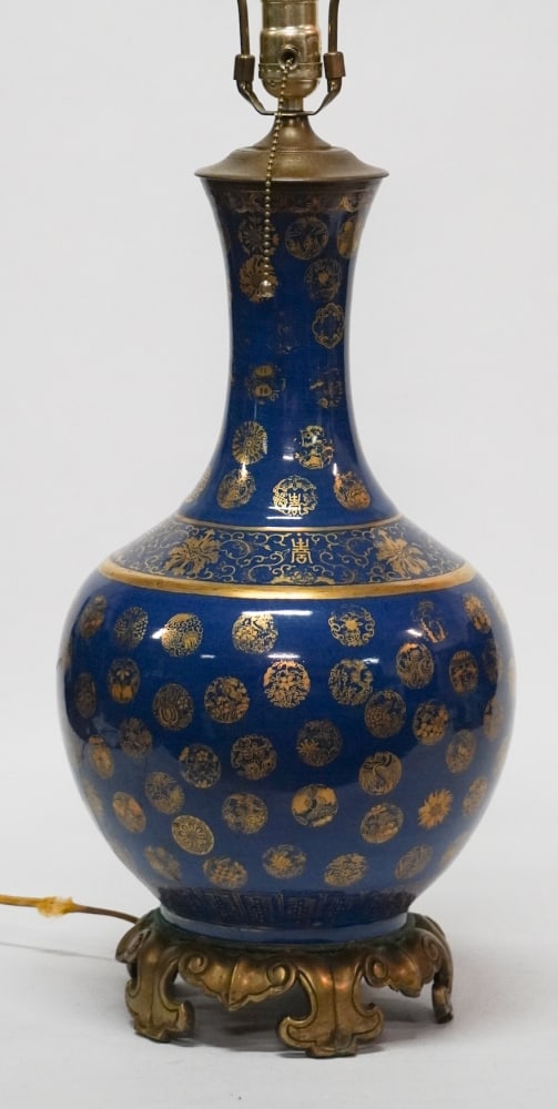 Antique Chinese Qing Period Porcelain Vase Converted to Lamp: 19th century. Qing period vase having excellent blue glaze with gilt decoration atop carved and gilded stand. The piece has been drilled but otherwise in good condition. Urn Size: H16" Total size: H33
