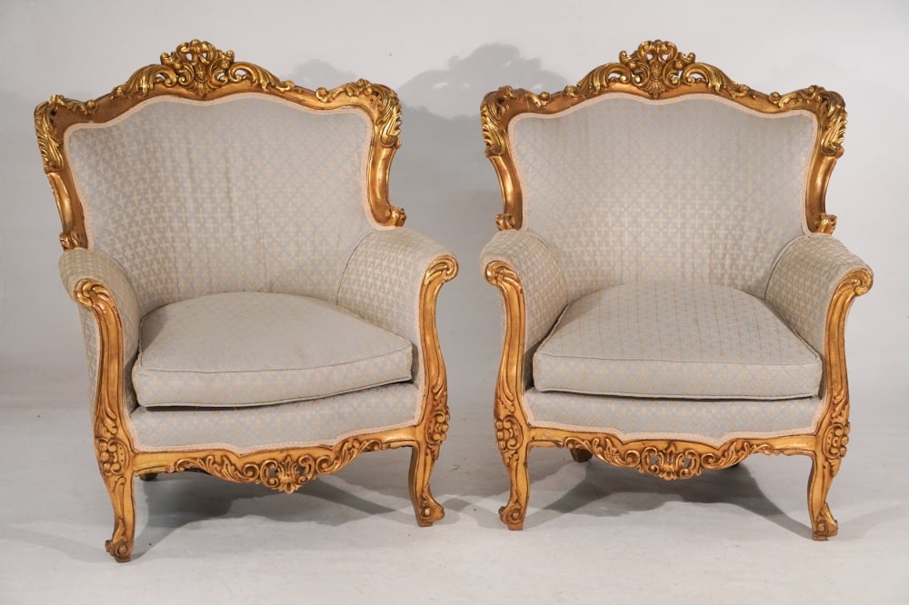 Pair French Rococo Style Gilded Easy Chairs: Circa 1910. Having fine form with carved frame boasting excellent gilded surface and upholstered nicely. H39" W32" D26" Sold from the collection of a Charleston, South Carolina gentleman.
