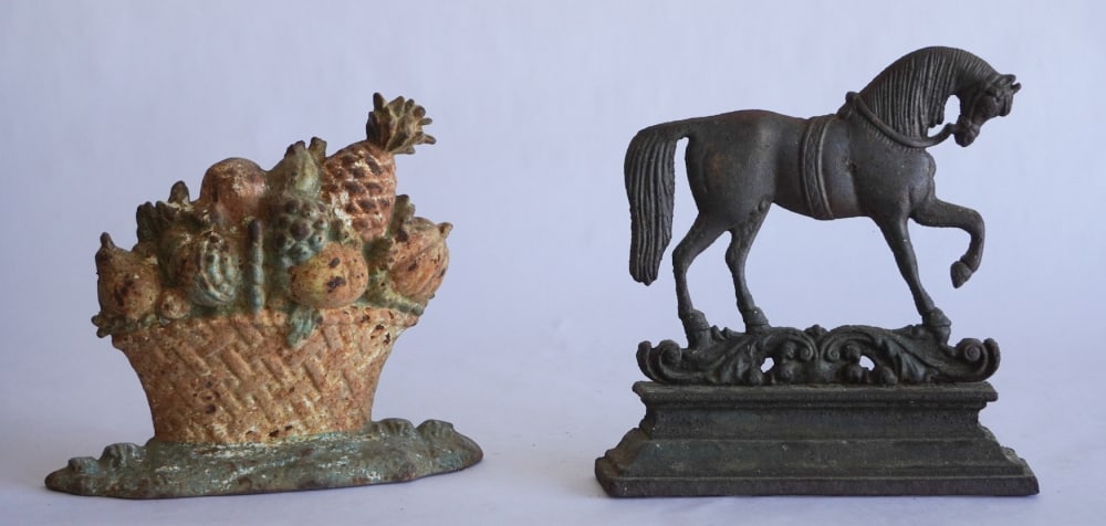 Two Antique Cast Iron Figural Door Stops: Circa 1900. The lot includes a handsome horse and a flower basket. Each with a nice patina throughout. H11" Sold from the collection of a Camden, South Carolina family.