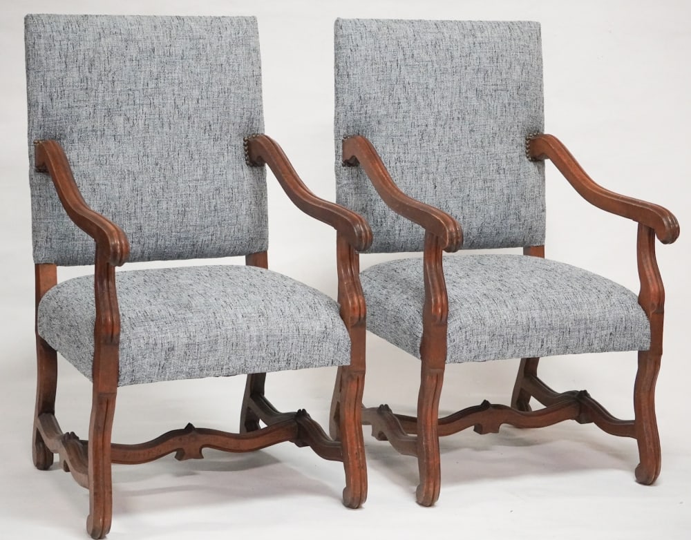 Handsome Pair of French Provincial Style Carved Walnut Arm Chairs: 20th century. Having handsome form with quality upholstery and nice scrolling frame which is good and sturdy. Well kept chairs ready to be used. H34" W25" D27" Sold from the collection of a