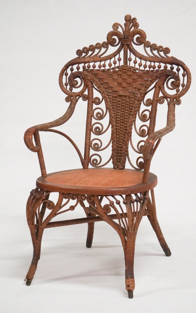 Handsome Antique Wicker Arm Chair: Late 19th century, likely by Heyward Wakefield. Very delicately woven and charmingly designed example. Generally tight well cared for condition, sturdy. H39 3/4" Sold from the collection of a Camden,