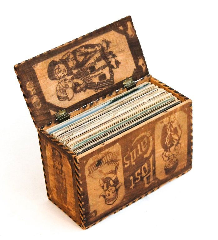 Group of postcards in vintage wooden postcard box