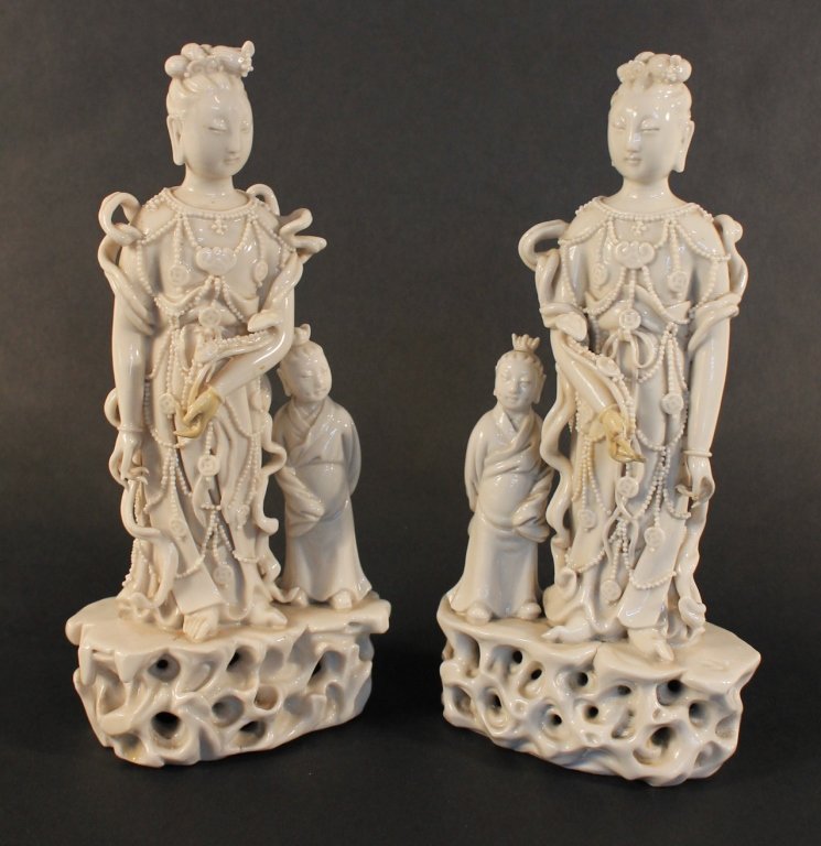 Pair Blanc de Chine Porcelain Figures of Guanyin: China, Qing Dynasty. Buddhist goddess of mercy, holding a ruyi and standing with a child. H9 ½” W4 ½”