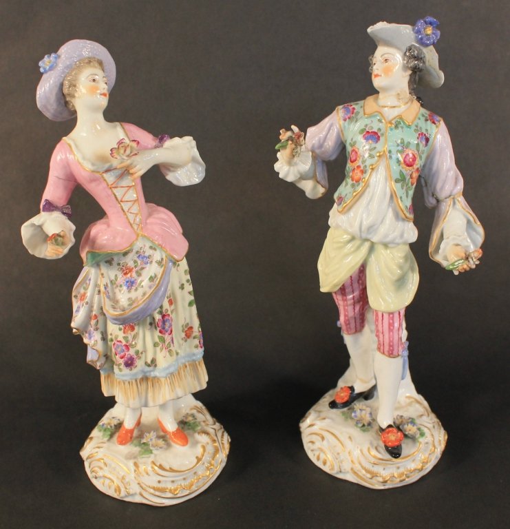 Pair of Edme Samson Porcelain Figures: French, 19th century. gentleman and a lady holding flowers, wearing floral-patterned attire. with gilt detailing. both bearing crossed swords mark on base. H8 ½” W3”