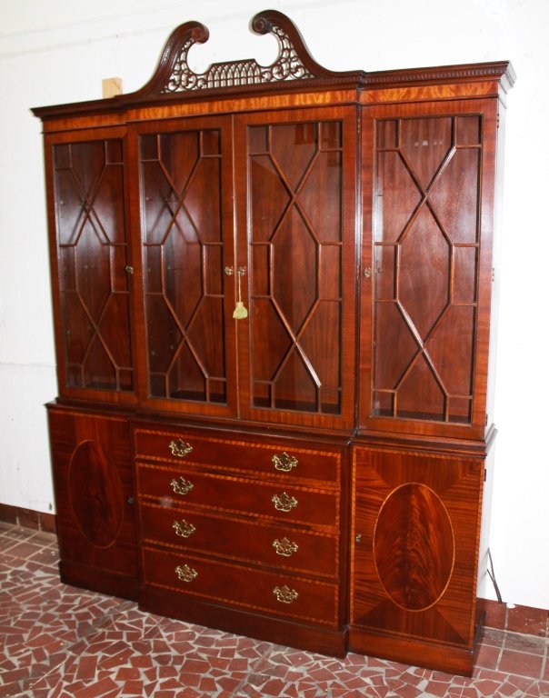 Baker Furniture Inlaid Mahogany Breakfront: Chippendale style with broken-arch top and pierced pediment, glazed doors, base with drawers and doors. H94 1/2" W75 1/2" D15" From the Private Collection of Mr. Carl Butler, Clayton, Georgia.