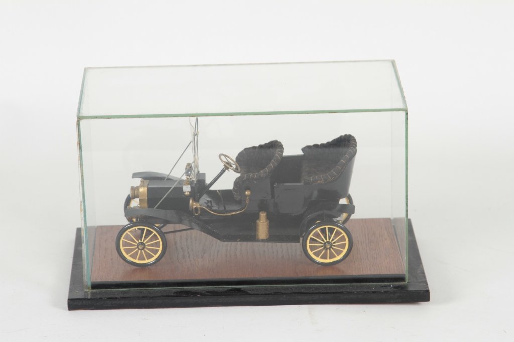Ford Model T Car Model: circa 1908 Model T. in glass case. H7” W12” D7” From the Private Collection of Mr. Carl Butler, Clayton, Georgia.