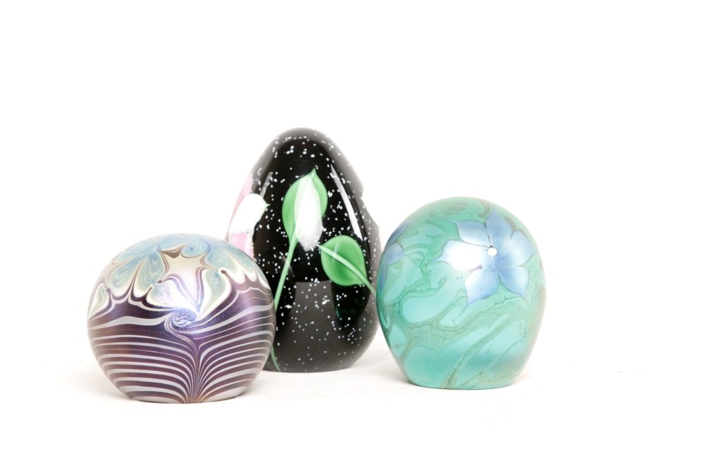 Three Art Glass Paperweights: by Vandermark and Orient & Flume. two iridescent paperweigts signed: "Vandermark-1978" and "Vandermark-85"; together with hand cooler signed "Orient & Flume-Cater- PO46193286." From the Estate of Anit