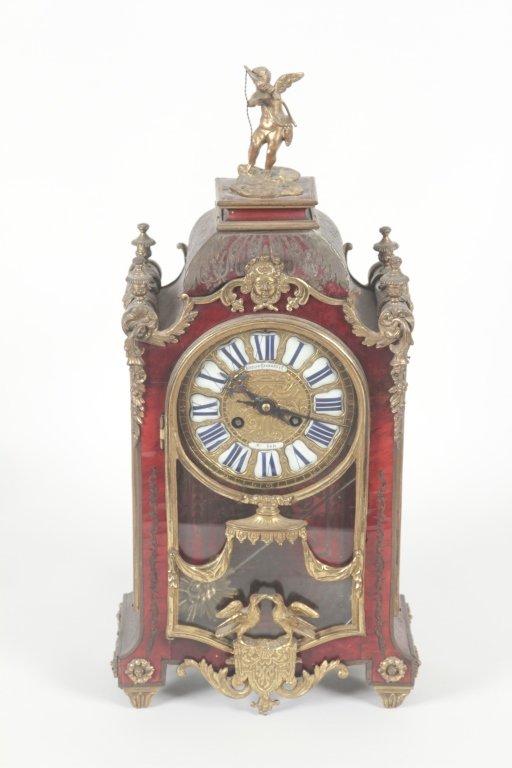 French Boulle Mantel Clock, Japy Freres: late 19th century. brass inlaid and bronze mounted mantel clock made for Bigelow & Kenard, Boston, MA; brass dial with porcelain inserts, sunburst pendulum. H19" W9" D5 /2" Private Collection, Greenvi