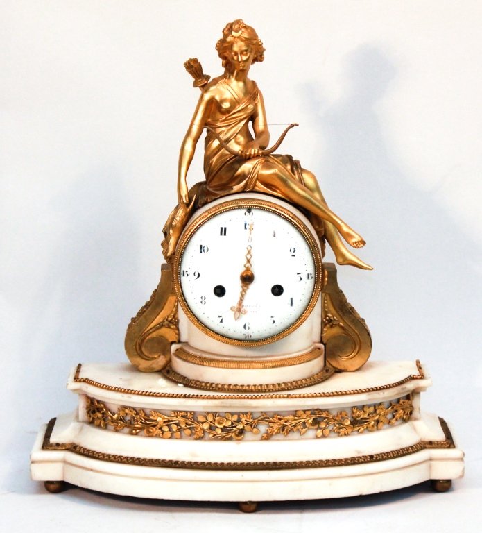 French Ormolu Mounted Marble Mantel Clock: Paris, circa 1875. white marble case with gilded bronze mounts and huntress figure on top. H16 1/2" W15" From a Private Southampton, New York Estate.