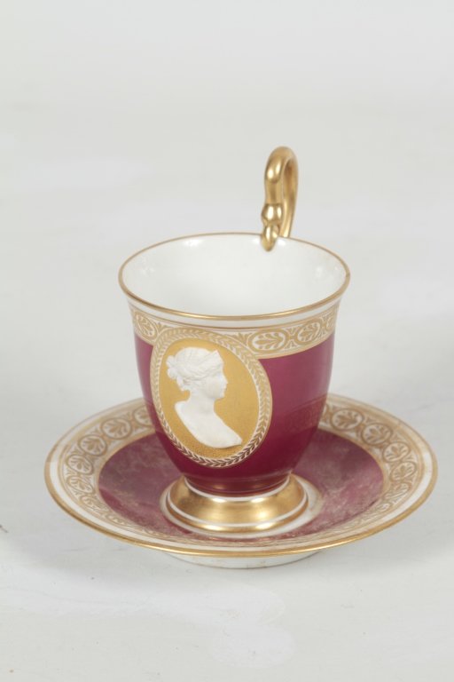 Neoclassical Style KPM Berlin Porcelain Teacup: late 19th/early 20th century. cup and saucer by the Royal Porcelain Factory (Königliche Porzellan-Manufaktur) Berlin, Germany. gilded cup and saucer, cup features a central medallion with an applied 