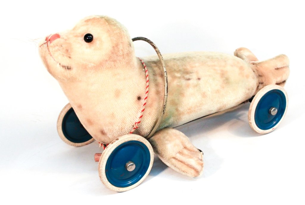 Antique Steiff Seal Pull Toy: stuffed seal attached with ties to a rolling frame. bearing steiff tag on tail. H15 ½” W28” From a Private Southampton, New York Estate.
