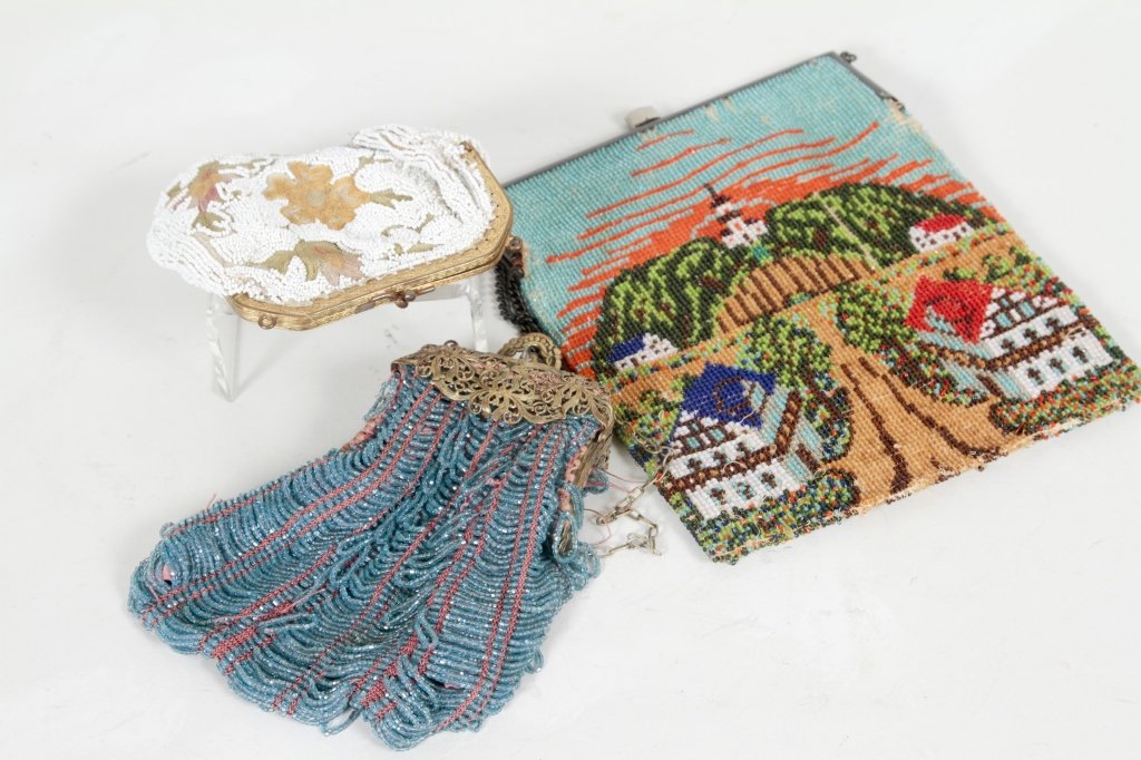 Collection of Three Beaded Purses: beaded and embroidered "Longchamps, France" coin purse together with purse with beaded village scene and beaded purse with filigree clasp. From a West Palm Beach Private Collection.