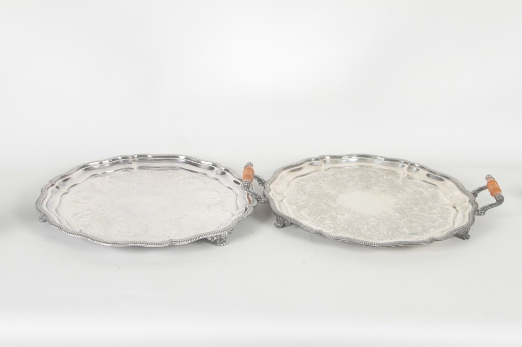 Two Footed Silver Plated Serving Trays: by Crown Silver, a division of International Silver. one with handles, both with etched decoration. Dia.18 ½” From the Private Collection of Mr. Carl Butler, Clayton, Georgia.
