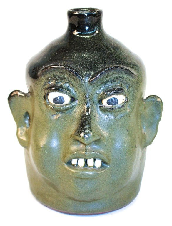 Fine Southern Stoneware Face Jug: Lanier Meaders, Georgia. circa 1970. signed on base with alkaline and army green glaze. H8 1/2" W7 1/4" From the Private Collection of Mr. & Mrs. Gary Thompson, Travelers Rest, South Carolina. Note: G