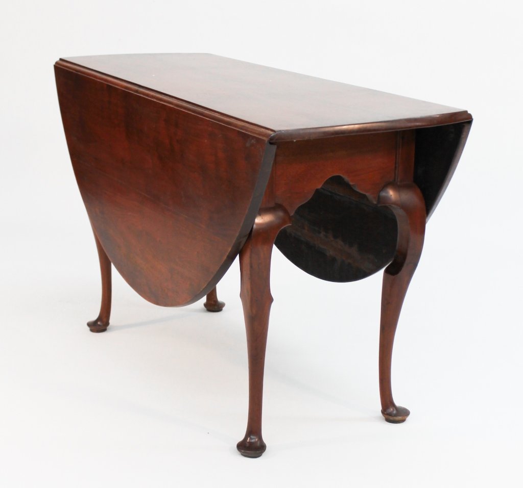 Southern Queen Anne Walnut Dining Table: probably Virginia or North Carolina, mid 18th century. round top with two drop leaves above shaped skirt supported by cabriole legs terminating in pad feet; two legs swing out to support leaves. H29"