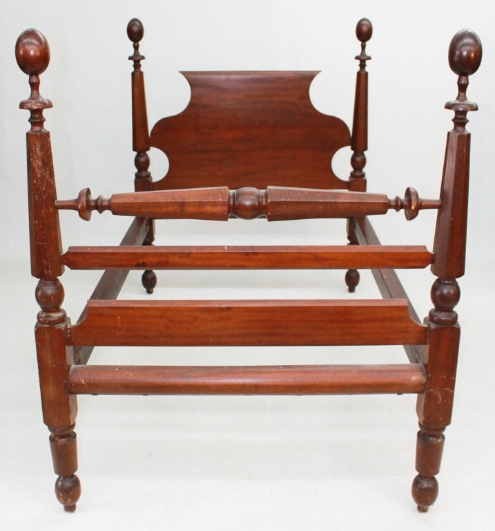 Classical Walnut Four Post Bed: probably Southern, circa 1840. tapering hexagonal posts with turned legs and finials support shaped headboard and blanket- roll. H62 1/2" W51 1/2" L81 1/2"