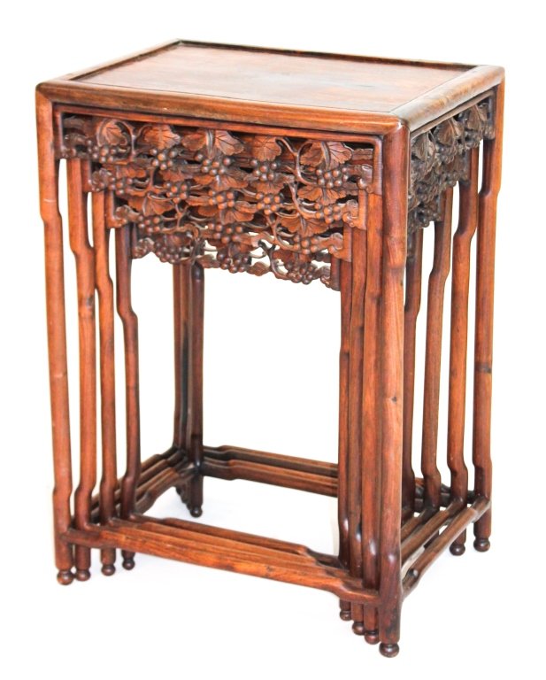 Set of Chinese Hardwood Nesting Tables: 19th century. set of four nesting tables with carved grape leaf cluster carved frieze on bamboo style legs. largest H28 1/2" W20 1/2" D15"