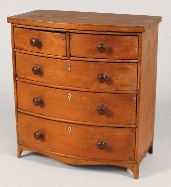 Hepplewhite Miniature Pine Bowfront Chest: early 19th century. shaped top above conforming case fitted with two short and three long, graduated drawers on French feet. pine throughout and all drawers are dovetailed. H13" W12 1/4" D7" Private U