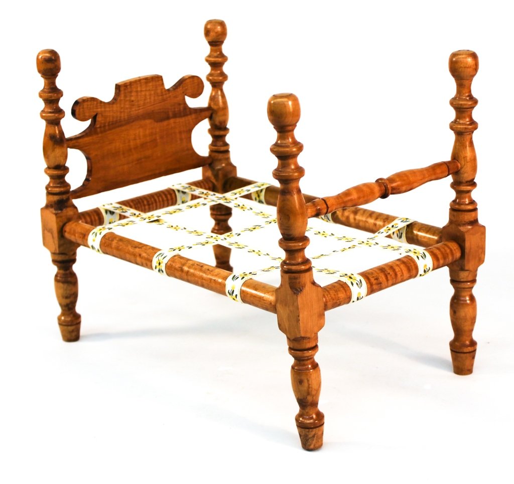 Classical Style Tiger Maple Doll Bed: 20th century. shaped headboard, block and turned posts and turned rails. H13 1/4" L16" W10 1/8" Private Upcountry, South Carolina Collection.